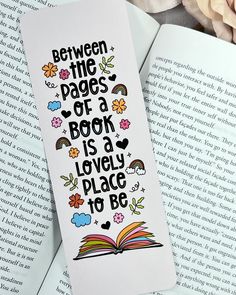 a bookmark with the words between the pages of a book is a lovely place to be