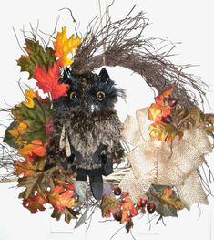 an owl sitting on top of a wreath