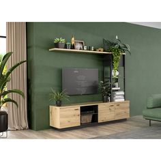 a living room with green walls and plants on the shelves, along with a couch