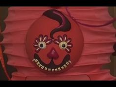 a red paper lantern with a face painted on it