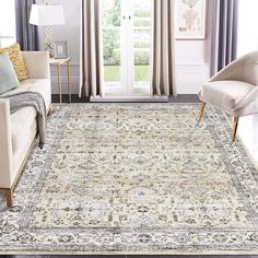 a living room area with couches, chairs and rugs