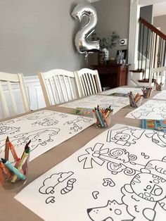 the table is set up with markers and crayons to draw pictures on paper