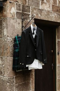 Groom's traditional kilt and black tie outfit hanging on wooden hangers Wedding Cake With Gold Flakes, Cake With Gold Flakes, Black Tie Outfit, Wedding Cake With Gold, Black Kilt, Square Wedding Cake, Black Tie Outfits, Cake With Gold, Emerald Green Bridesmaid Dresses