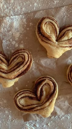 three heart shaped pastries on wax paper