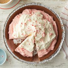 a pie with white frosting and sprinkles on it