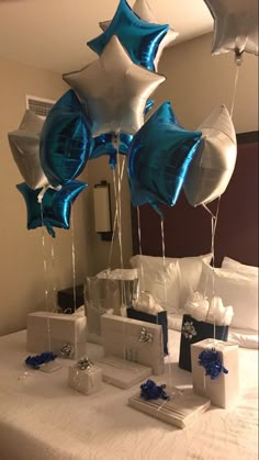 some blue and white balloons are on a bed