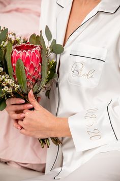 a woman holding a bouquet of flowers in her hands