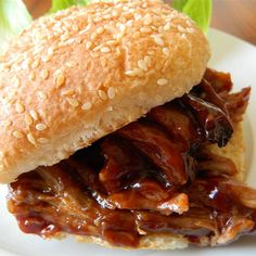 a close up of a sandwich on a plate with lettuce and meat in it