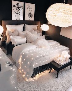 an instagram photo of a bedroom with white bedding and lights on the walls