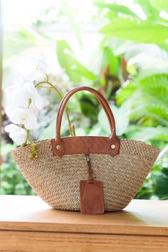 Seagrass Everyday Handbag Vacation Bag Unique Holiday accessory French Market Basket Natural bag Modern Boho style large tote shopping bag with a natural color, the bag is flexible for any outfit absolutely eco-friendly, handmade beach basket bag made of Seagrass and genuine leather handles leather color in caramel brown and dark brown color.  The straps are thick and durable. The bag is perfect for everyday wear in the city as well as for shopping or going to the beach. The tote Bag will add charm to your everyday look.   ● Material: Seagrass, leather, Calico Lining, Zipper ●Quantity listed: 1pc ●Dimension: Length: 48-50 cm Height: 28-30 cm Height of handles: 28-30 cm, Bottom Width - 30 cm Color available: 1pc brown leather only ●PACKING: We'll wrapped it in single face corrugated paper, French Market Basket, Beach Basket, Vacation Bag, Everyday Handbag, Market Basket, French Market, Rattan Bag, Market Baskets, Woven Rattan