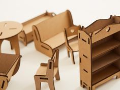 several cardboard furniture made to look like children's beds and desks are shown