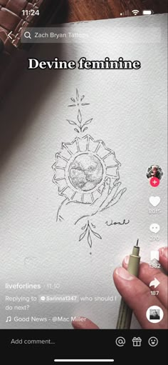 someone is drawing something on paper with a pen and some other things in the background