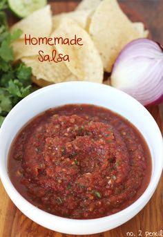 homemade salsa in a bowl with tortilla chips on the side