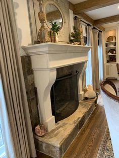 a living room filled with furniture and a fire place in the middle of a room