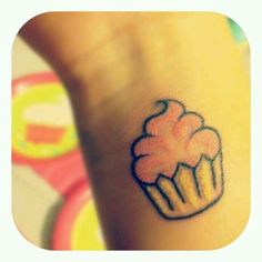 a small cupcake tattoo on the wrist