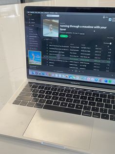 an open laptop computer sitting on top of a table