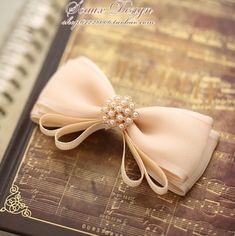 a close up of a book with a bow on it