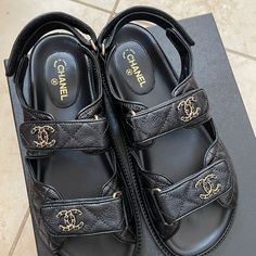 New Full Set With Receipt Chanel Caviar Dad Sandals In Black Original Packaging : 2 Dust Bags, And Box Made In Italy Style Code : G35927 X56140 94305 These Stylish Sandals Are Crafted Of Black Grained Calfskin Leather. These Sandals Feature Velcro Ankle Straps And A Gold Chain Leather Threaded Chanel Logo On The Uppers. These Are Excellent Shoes For A Timeless Look Only From Chanel! Dad Sandals, Chanel Espadrilles, Chanel Black And White, Chanel Flats, Raffia Sandals, Italy Style, Chanel Sandals, Chanel Logo, Pink Chanel