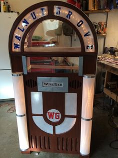 a wooden vending machine sitting inside of a garage