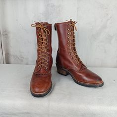 Great pair of packer, logger, work boots made by the Georgia Boot Company in the USA. Brown leather uppers with 11 rows of laces holes and hooks. 9 1/2 inches tall plus a 2 inch heel. Vibram soles. Very nice condition. Notice the picture of the solesvery little wear.  Stamped men's size 8 W (wide width).     Measurements: Sole length   11 inches Sole width     4 inches Rustic Lace-up Boots With Reinforced Toe, Rugged Plain Toe Boots With Laces, Western Steel Toe Lace-up Boots, Western Style Steel Toe Lace-up Boots, Western Lace-up Boots With Reinforced Toe, Western Style Lace-up Boots With Steel Toe, Western Style Lace-up Steel Toe Boots, Rugged Brown Work Boots With Laces, Brown Western Lace-up Work Boots