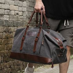 a man carrying a gray duffel bag