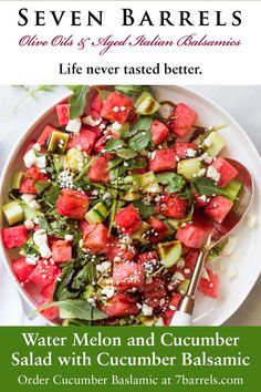 watermelon, cucumber and feta salad in a white bowl with a serving spoon