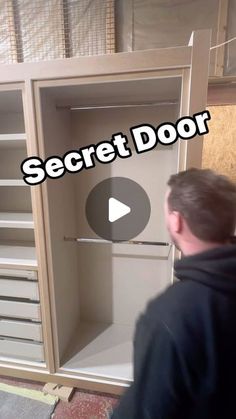 a man standing in front of a cabinet with the words secret door written on it