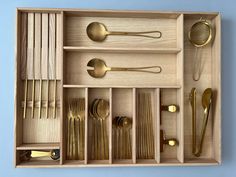 a wooden box filled with lots of silverware