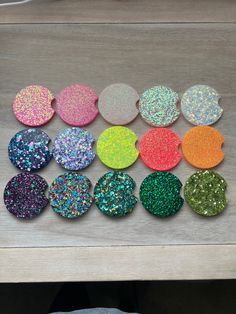 there are many different colors of glitter on the table and one is green, yellow, red, blue, pink, orange