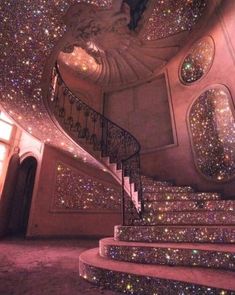 a spiral staircase with lots of stars all over the walls and floor in front of it