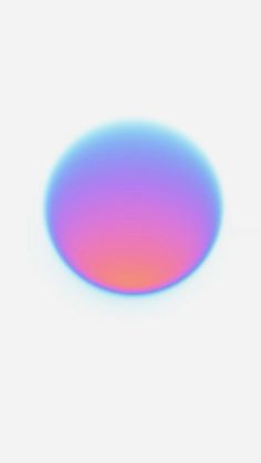 a blurry image of a blue and pink circle on a white background with the light reflecting off it's surface