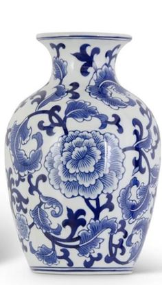 a blue and white vase with flowers on it