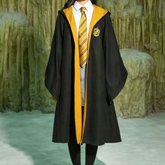 a person in a graduation gown and tie