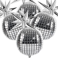 four shiny disco balls hanging from the ceiling with starbursts on them in black and white