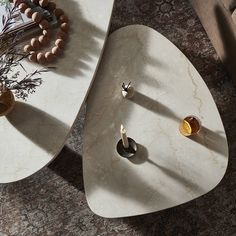 two tables with rings and beads on them