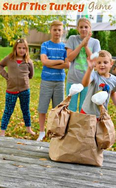 a group of children standing around a bag on top of a wooden table