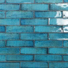 a blue brick wall that looks like it has been painted