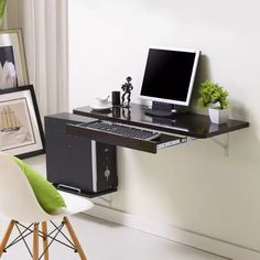 a computer desk with a monitor and keyboard on it