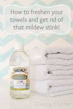 a bottle of vinegar sitting next to some folded towels