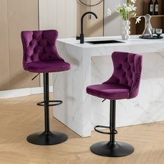 two purple barstools in front of a white counter