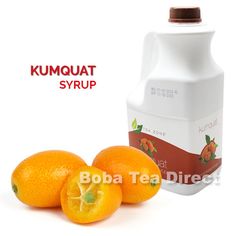 two oranges next to a bottle of syrup on a white background with the words kumquat syrup