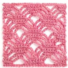 the crocheted square is made up of pink yarn and has an intricate design