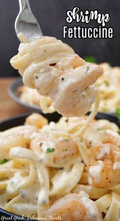 shrimp fettuccine being lifted from a bowl