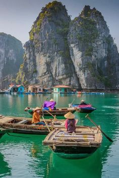 two boats in the water with people on them and mountains in the background at daytime