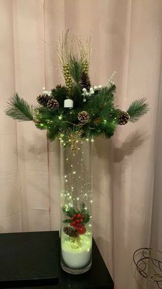 a vase filled with christmas decorations on top of a table