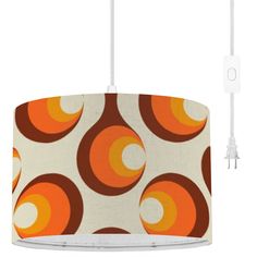 an orange and white lampshade with circles on it