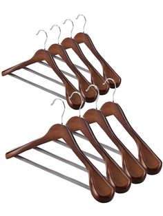 four wooden hangers with metal clips on them