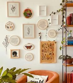 a living room filled with lots of pictures and plants