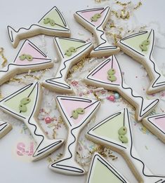 some decorated cookies are laying on the table