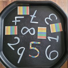 a black tray with white numbers and colored stickers on the side that says fix 5